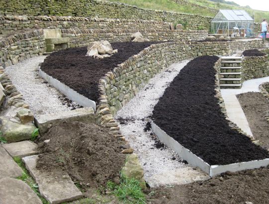 Topsoil into the flower beds